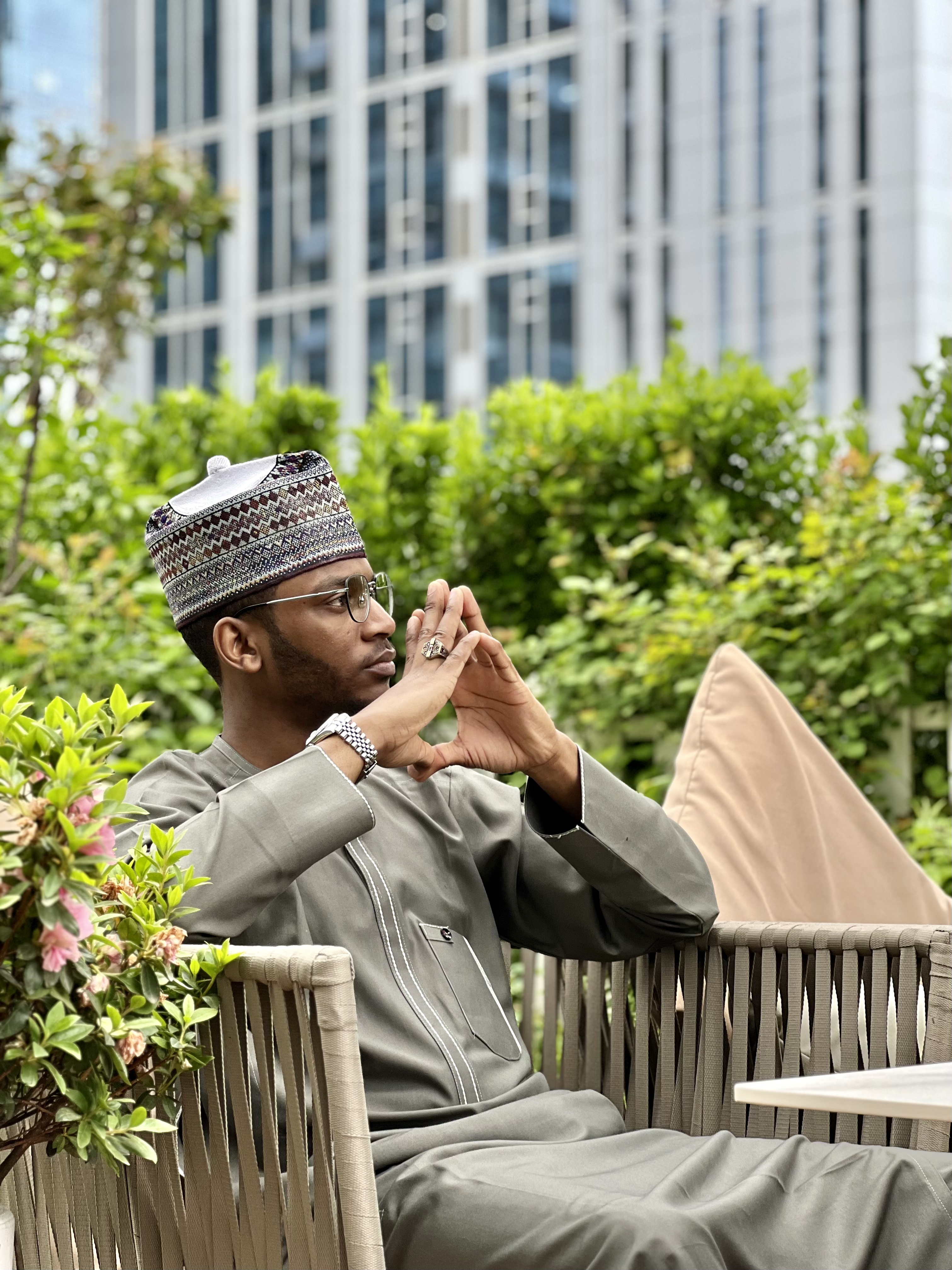 Ahmad Auwal seated outdoors in traditional attire
